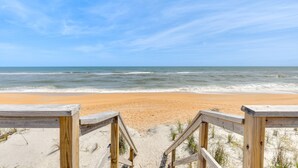 A wooden beach deck leading to a sandy beach with ocean views. - Oceanfront Flagler Beach Home w/ Decks & Gas Grill (Flagler Beach)