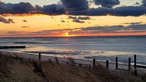 A beach scene with a sunset, ocean, and sandy shore. - Beechwood by the Bay Dog Friendly (Lower Township)