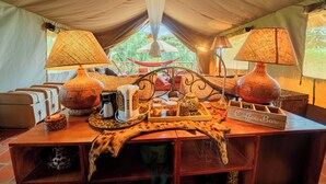 A tent interior with a coffee bar, lamps, and a hammock. - Longonot Buffaloe's Rest Greenpark Naivasha (Naivasha)