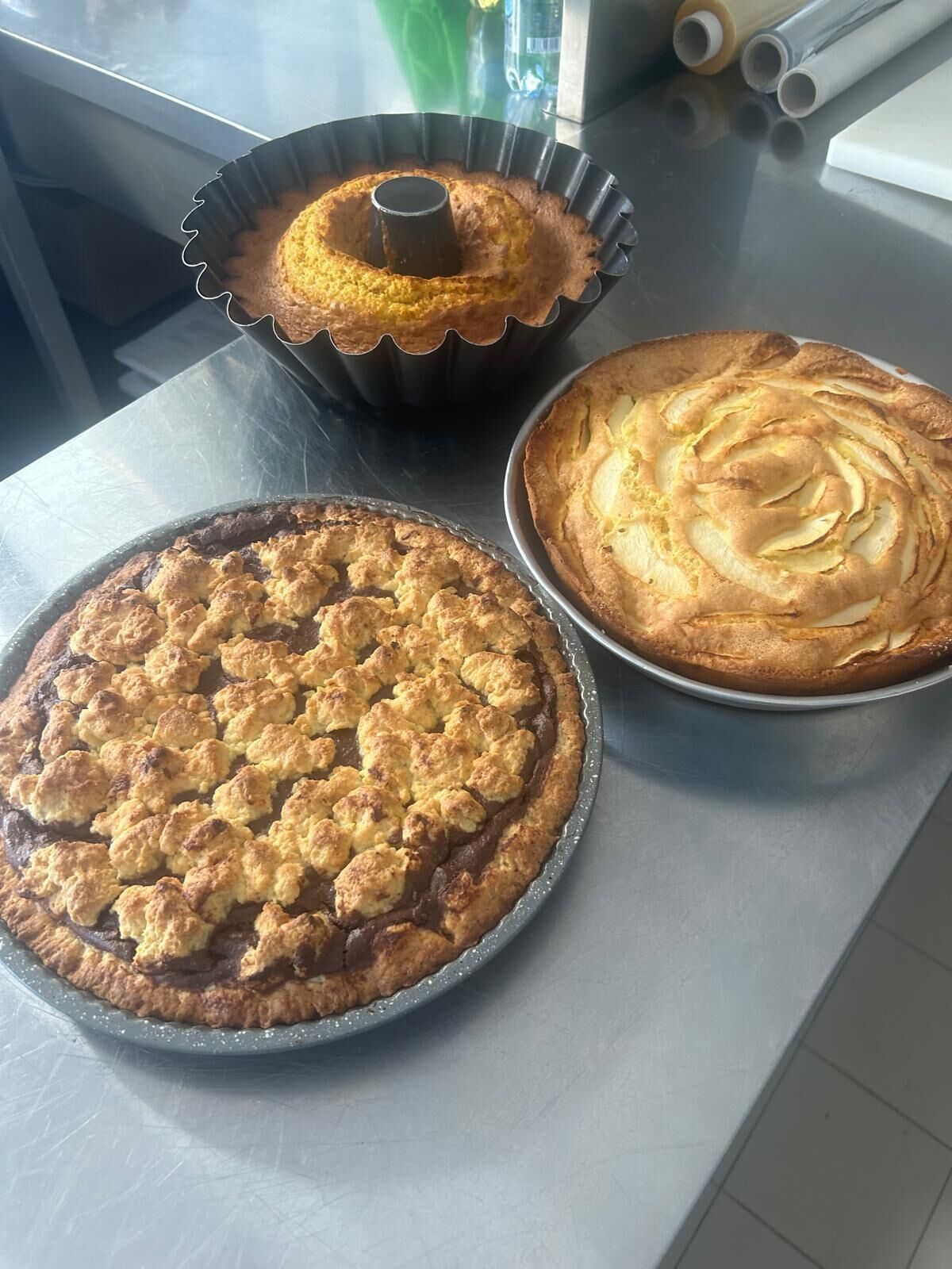 Three cakes on a kitchen counter.