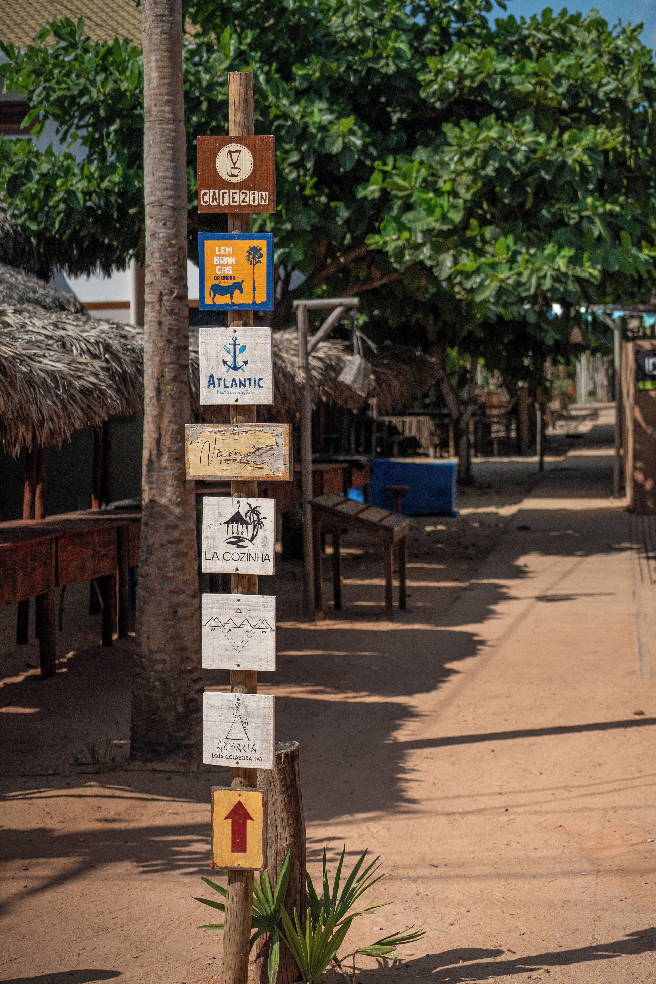 A signpost with multiple directional signs, including 'Atlantic Restaurant Bar' and 'Cagezon'.