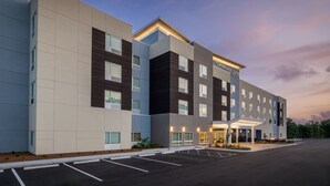 A modern hotel building with a flat facade, multiple windows, and a sign reading "TOYNEPLACE SUITES". - Towneplace Suites by Marriott Brunswick (Brunswick)
