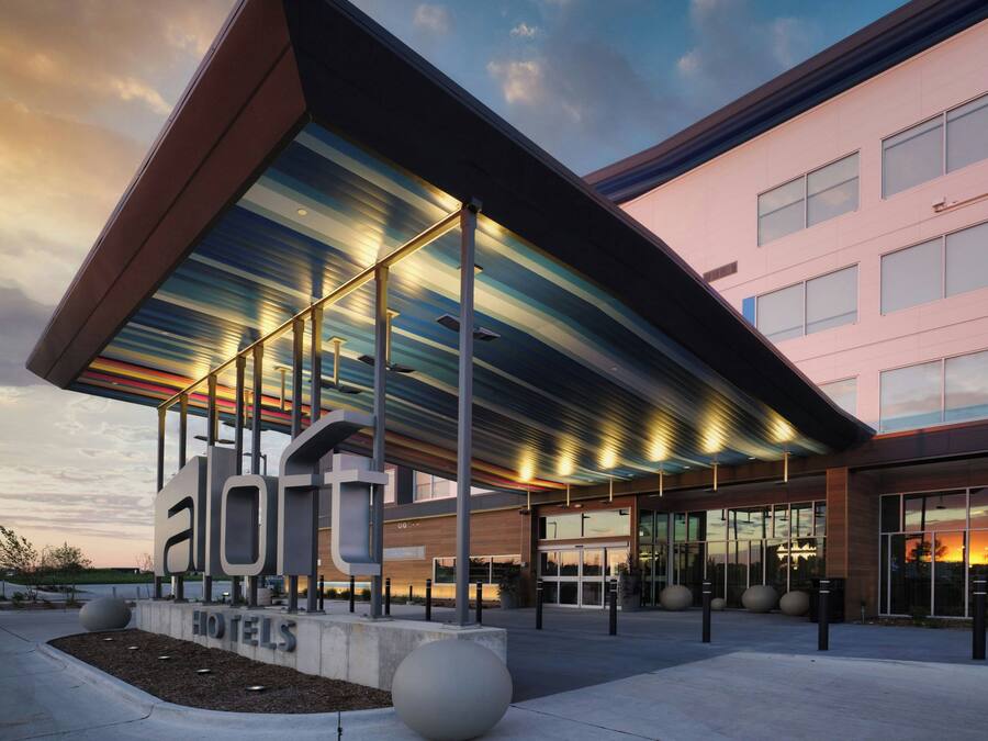 A modern hotel with a distinctive roof structure and a prominent 'HOTELS' sign.
