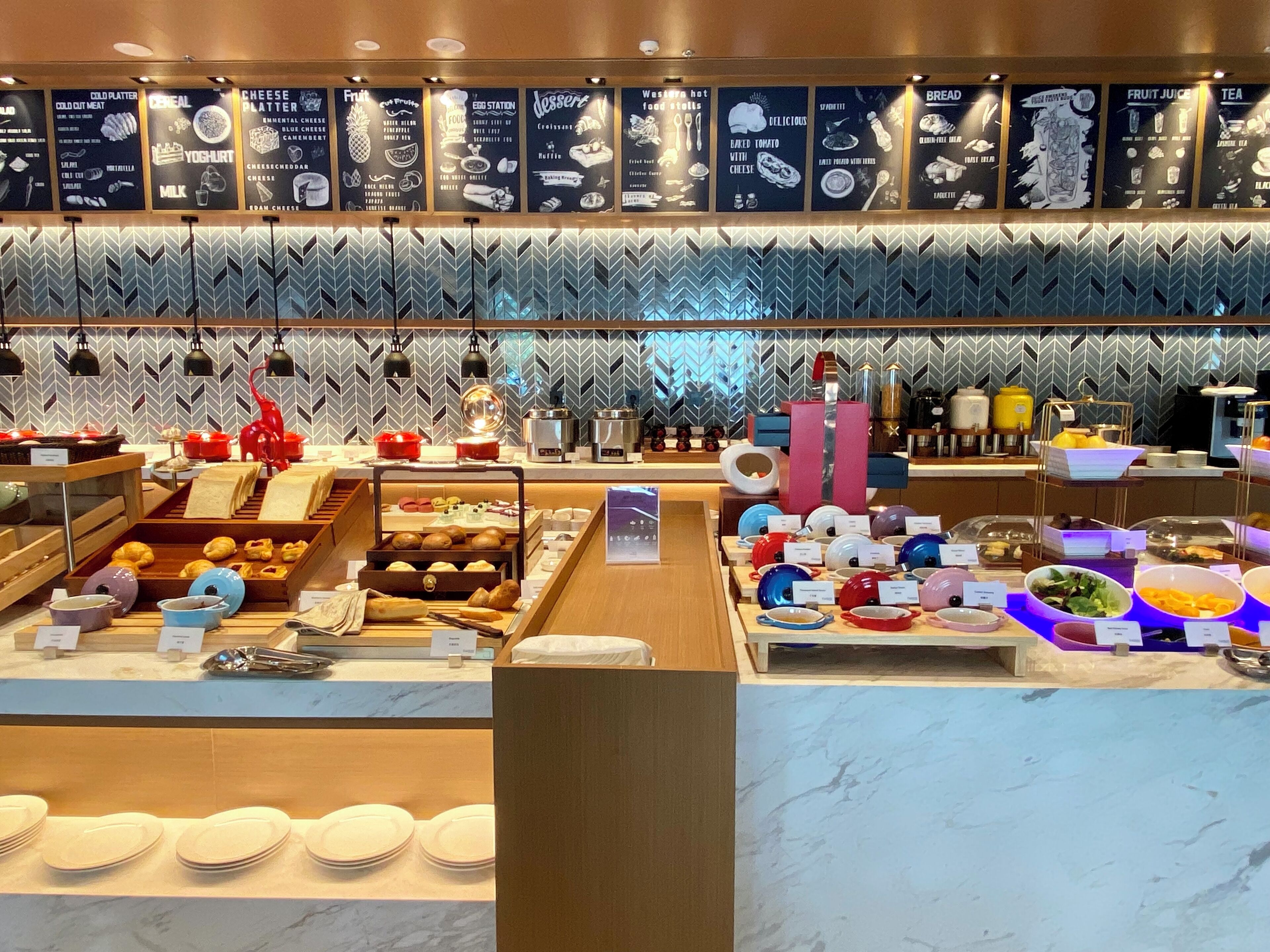 A breakfast buffet with various food options and a modern decor.