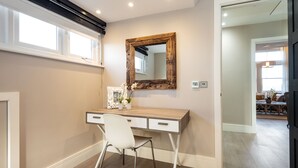 A modern bedroom with a wooden desk, a white chair, a large mirror, and a window. - Hampstead Lux Flat-Hosted by Sweetstay (London)