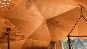 A cozy, tent-like interior with a bed, hanging chair, and wood-burning stove. - Ala Glamping (Mudurnu)