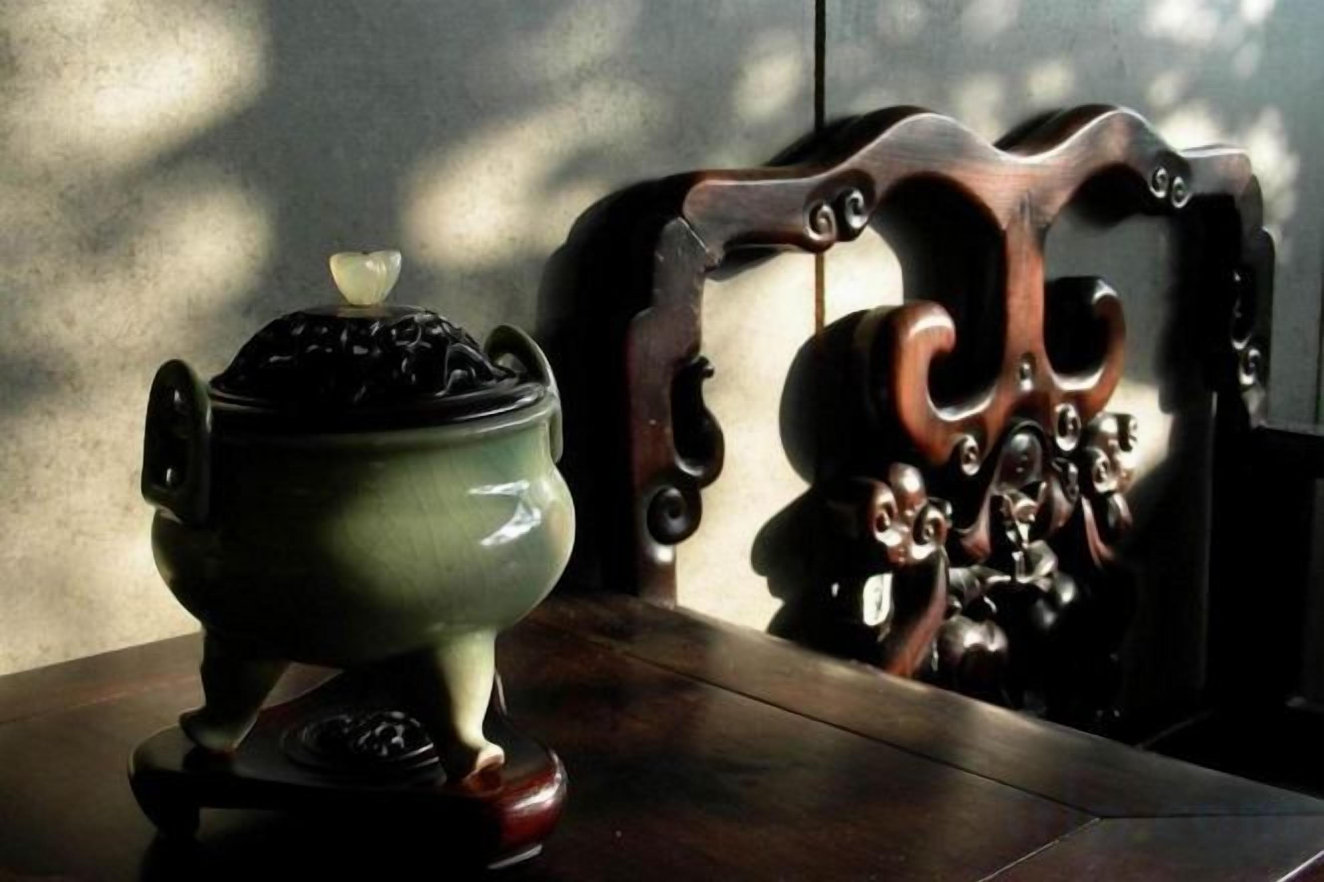 A ceramic pot on a wooden table with a chair in the background.