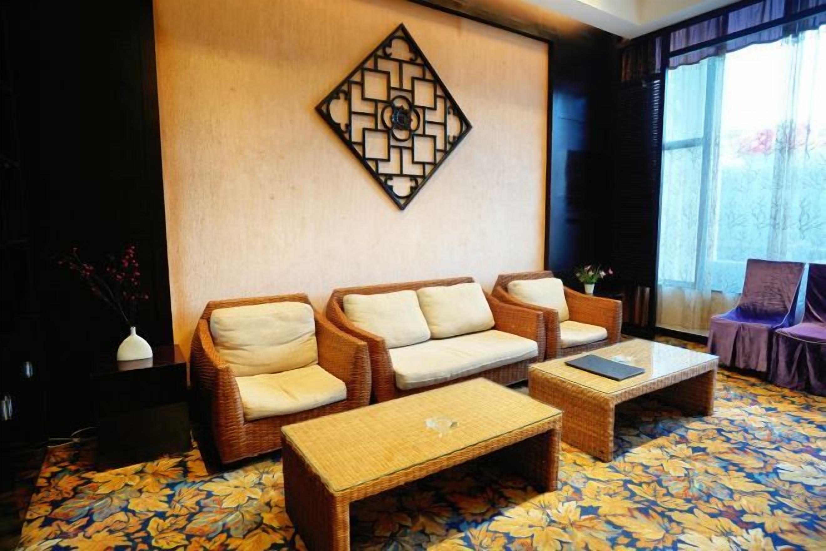 A living room with a sofa set, a coffee table, and a decorative wall piece.