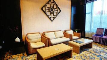 A living room with a sofa set, a coffee table, and a decorative wall piece.