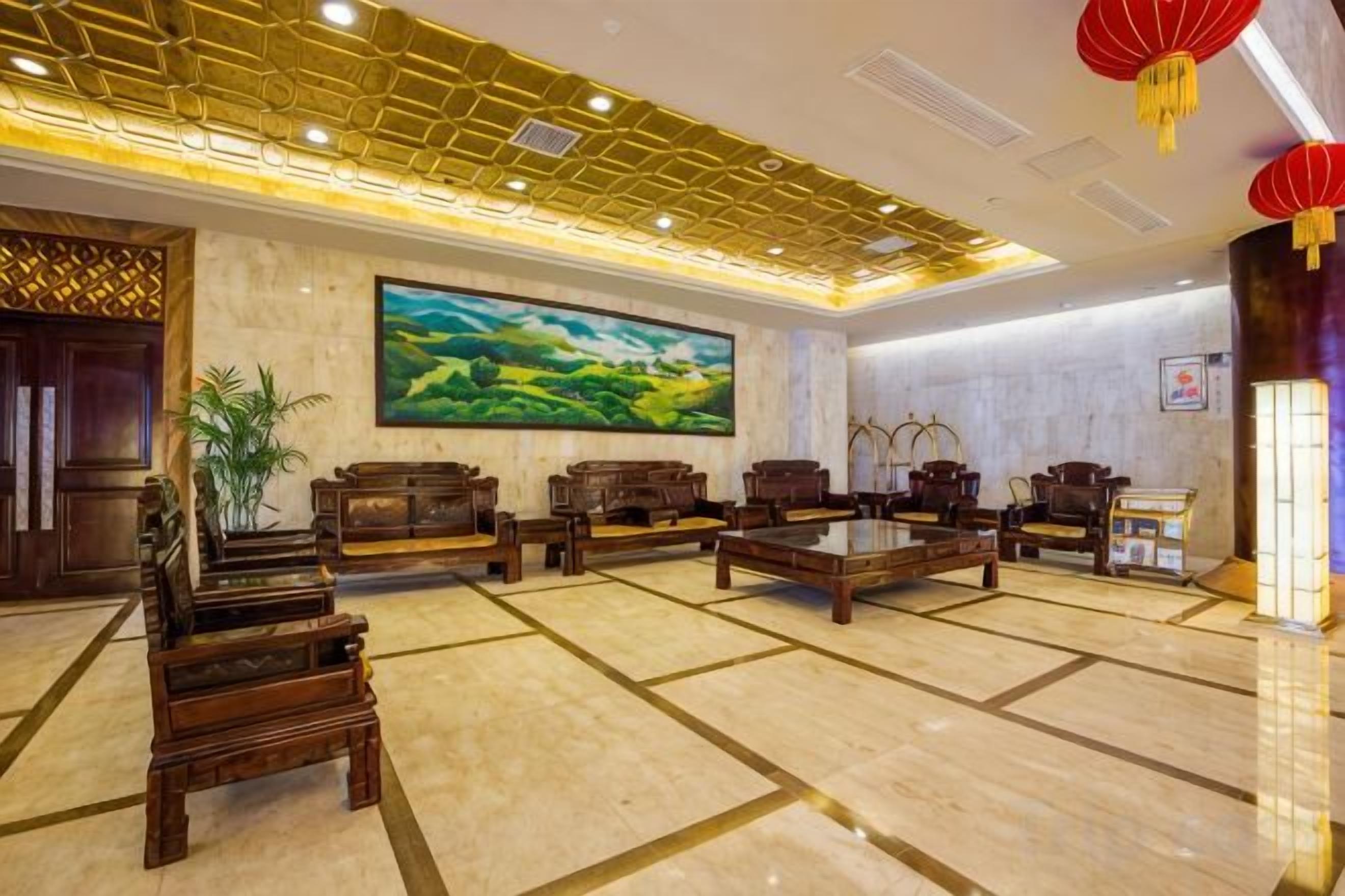 A lobby with a large painting, wooden furniture, and a patterned ceiling.