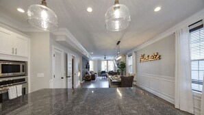 A spacious kitchen with granite countertops, a built-in microwave, and a stainless steel oven.