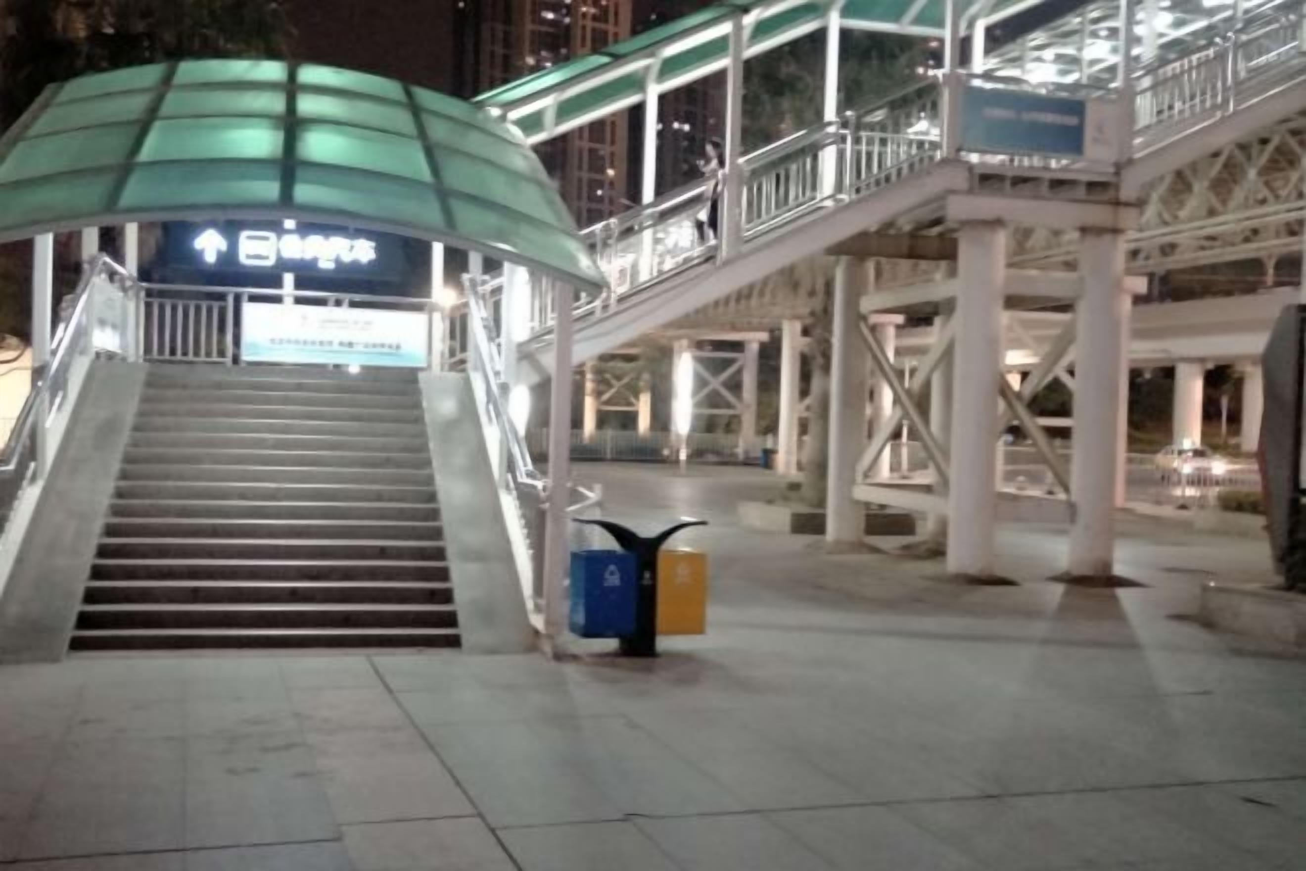 A pedestrian bridge with stairs leading to a building entrance.