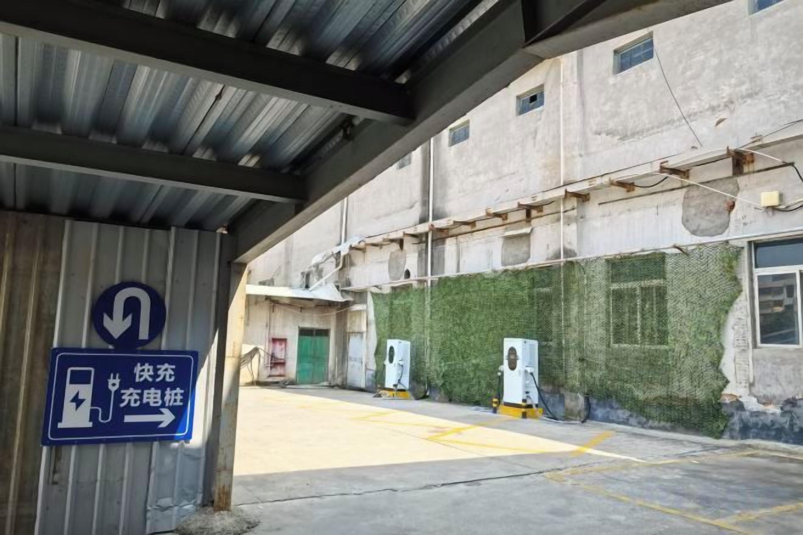 Un área de estacionamiento techada con un letrero que indica una estación de carga.