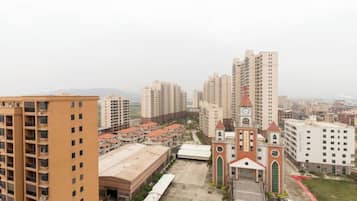 A high-rise building complex with a central courtyard, a clock tower, and surrounding residential buildings.