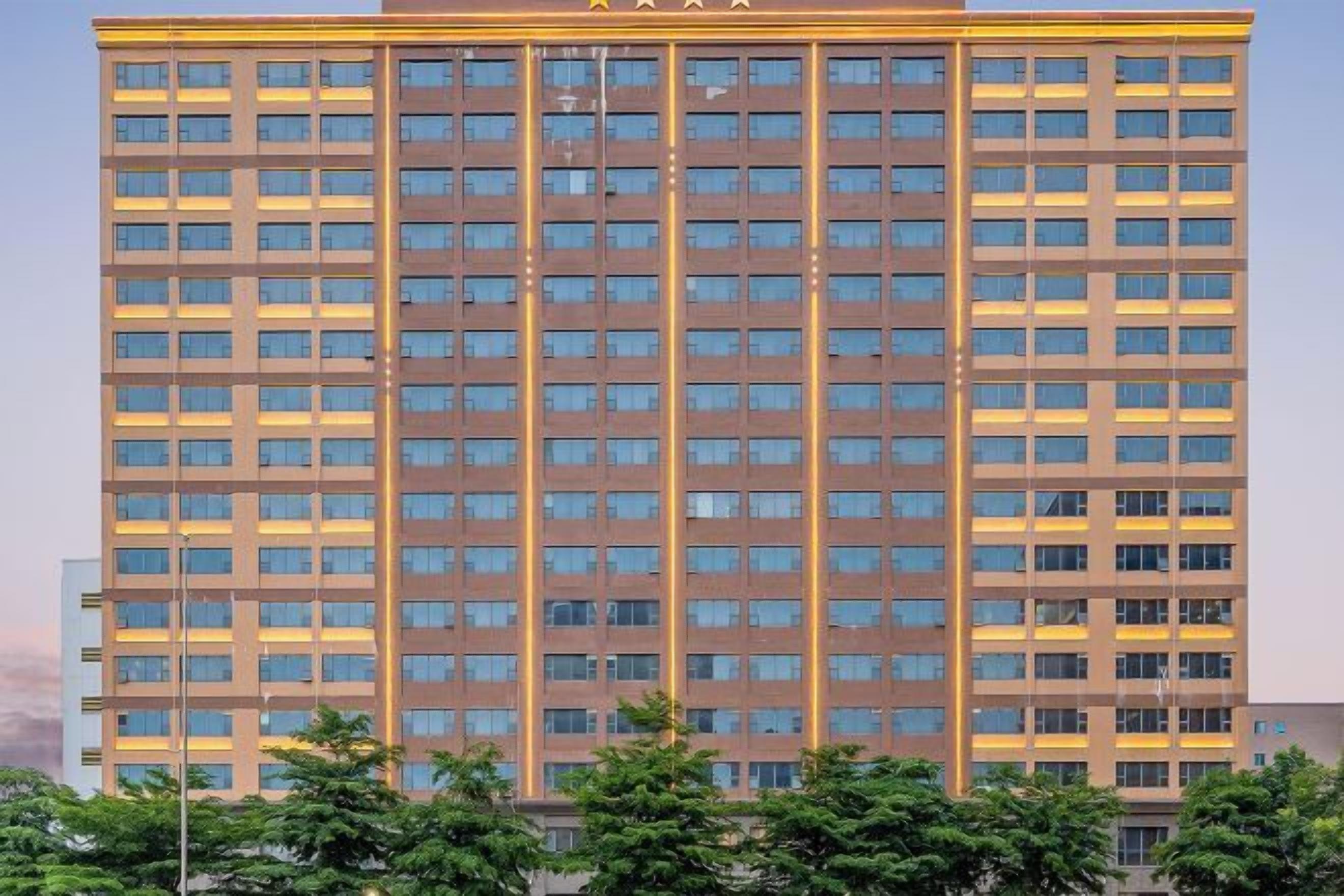 A tall, multi-story building with a grid of windows and a flat roof.