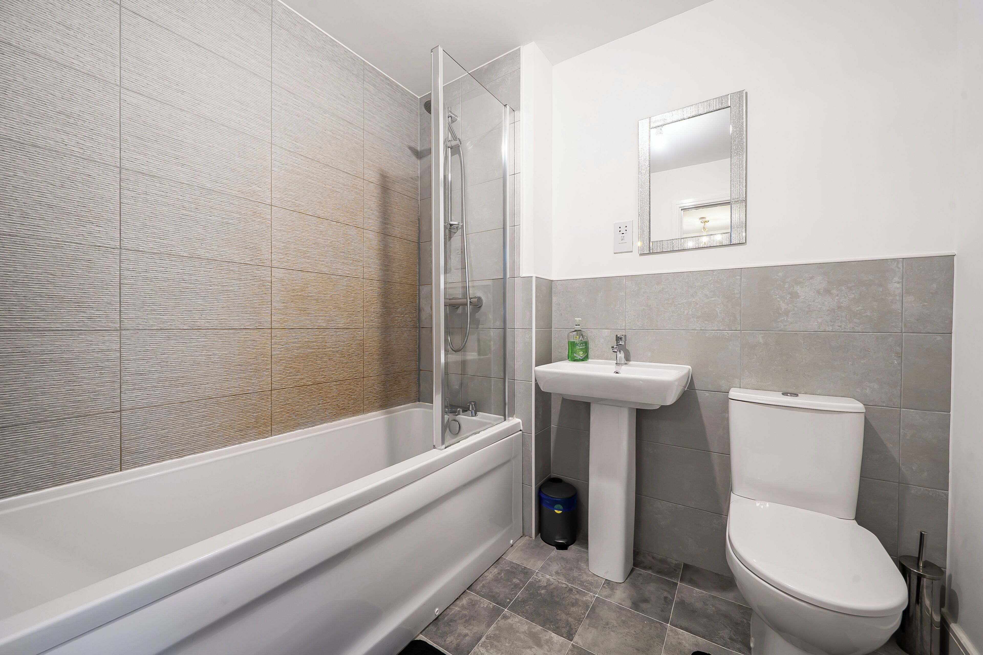 A bathroom with a bathtub, a sink, a toilet, and a shower.