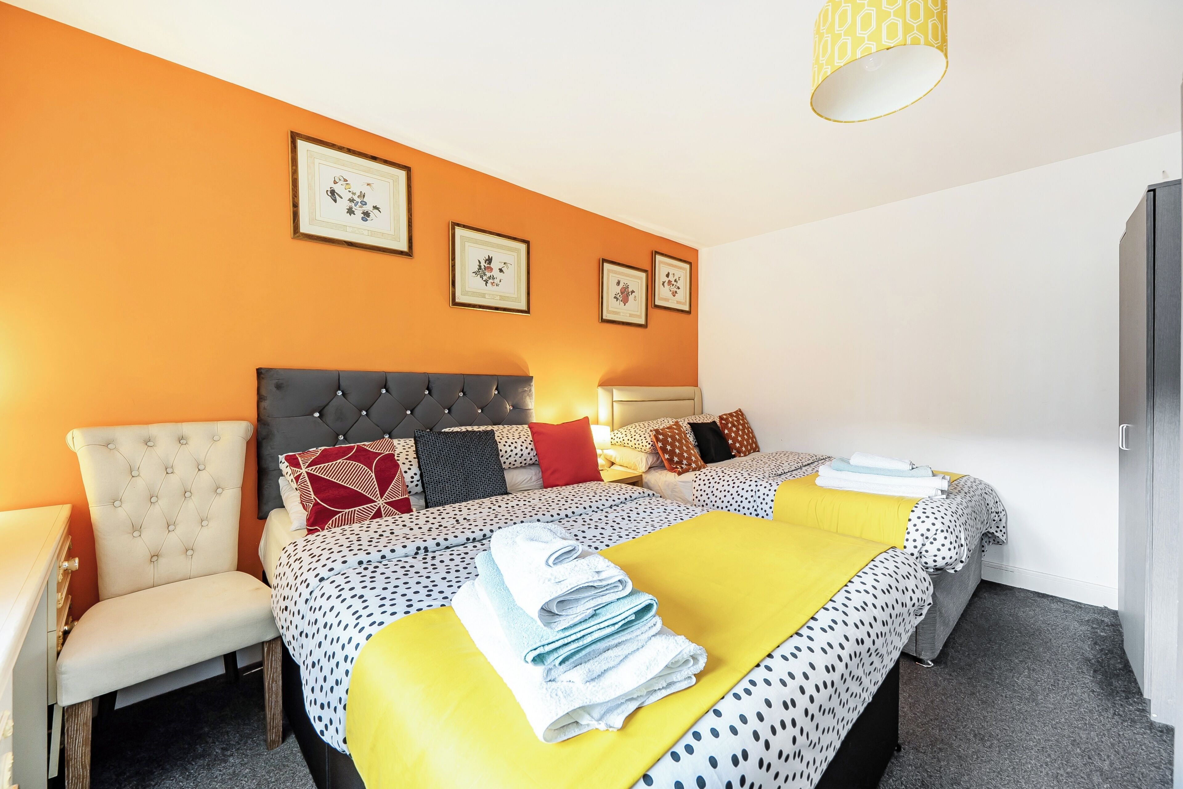 A hotel room with a bed, a chair, and a desk.