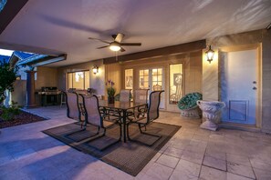 An outdoor patio with a dining table and chairs, a ceiling fan, and a grill. - 7 Bedroom 5 Bath Home in Mesa (Mesa)