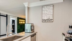 A modern kitchen with a built-in microwave, a sink, and a coffee machine. - Rare Exclusive Retreat Private Hot Tub King Bed (Arlington)