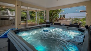 A hot tub with a view of a house and garden. - 🌴 Family Beach Retreat, Movie Theater, Game Room, Hot Tub, Near Ocean (Palm Coast)