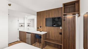 A modern kitchen with a white countertop, wooden cabinets, and a built-in dishwasher.