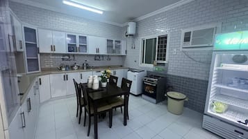Family Apartment | Private kitchen | Mini-fridge, stovetop, electric kettle, cookware/dishes/utensils