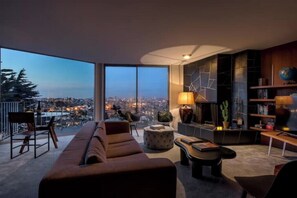 A modern living room with a large window offering a city view, a sofa, a coffee table, and a bookshelf. - Magical, Panoramic Views and Rare Parking in Central SF, 20 Min to Downtown (San Francisco)