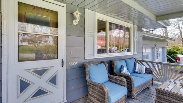 A porch with wicker furniture and a white door. - Cozy DuBois Home w/ Deck ~ 8 Mi to Treasure Lake! (DuBois)