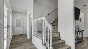 A staircase with white railings and wooden steps leading to a landing. - Waterfront house on Sam Rayburn (Brookeland)