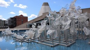 A modern pool area with abstract glass sculptures and a distinctive building in the background. - Private Getaway Near Beaches & Downtown Tacoma! (Tacoma)