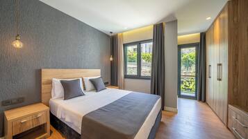 A modern bedroom with a large bed, wooden nightstands, and a wardrobe.