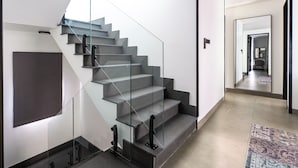 A modern staircase with glass railings and a minimalist design. - Laguna Park 4 Bedrooms Villa by NLA (Choeng Thale)