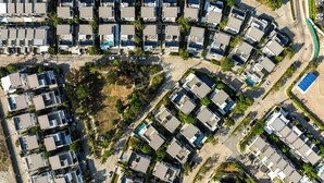An aerial view of a residential area with multiple two-story houses, each with a flat roof and a small front yard. - Laguna Park 4 Bedrooms Villa by NLA (Choeng Thale)