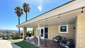 A covered patio with outdoor furniture, a grill, and a view of the landscape. - Fallbrook’s guest-pool house : An old Hollywood stars escape (Fallbrook)