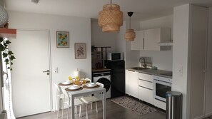 Enjoy cooking and dining in this well-equipped kitchen with appliances and a convenient dining area.