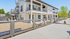 A two-story building with balconies and a sign that reads "The Loft."