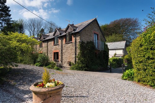 Traditional Byre Barn conversion with balcony off bedroom view North Devon Farm