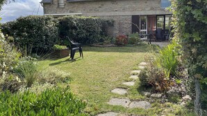A stone house with a sloped roof, a visible door, and a small window. - House for rent for eight people with garden and beach access (ARZON)