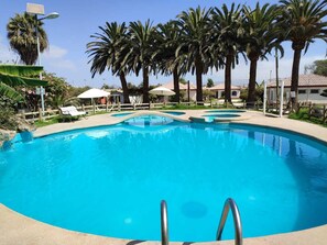 3 outdoor pools, open 11:00 AM to 8:00 PM, pool umbrellas
