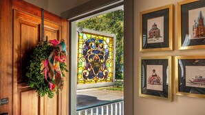 A wooden door with a wreath and a keycard reader.