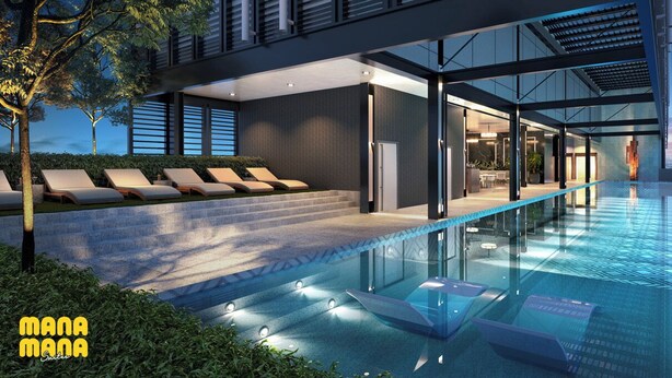Un edificio moderno con piscina infinita en la azotea, sillones de descanso y vistas a la ciudad.