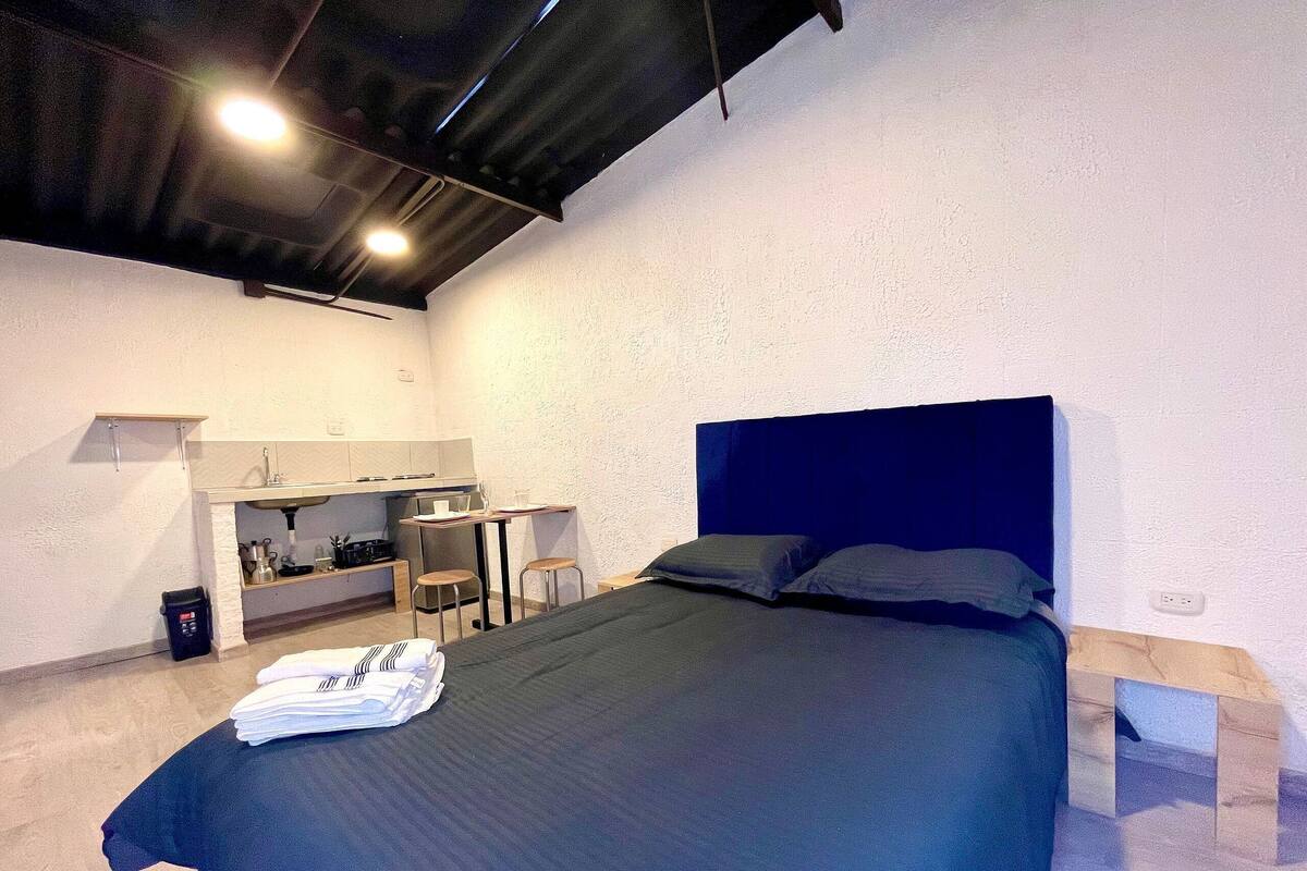 A modern bedroom with a bed, a desk, and a chair.