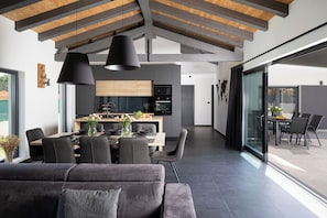 Enjoy meals in the spacious dining area with a wooden table and comfortable seating.