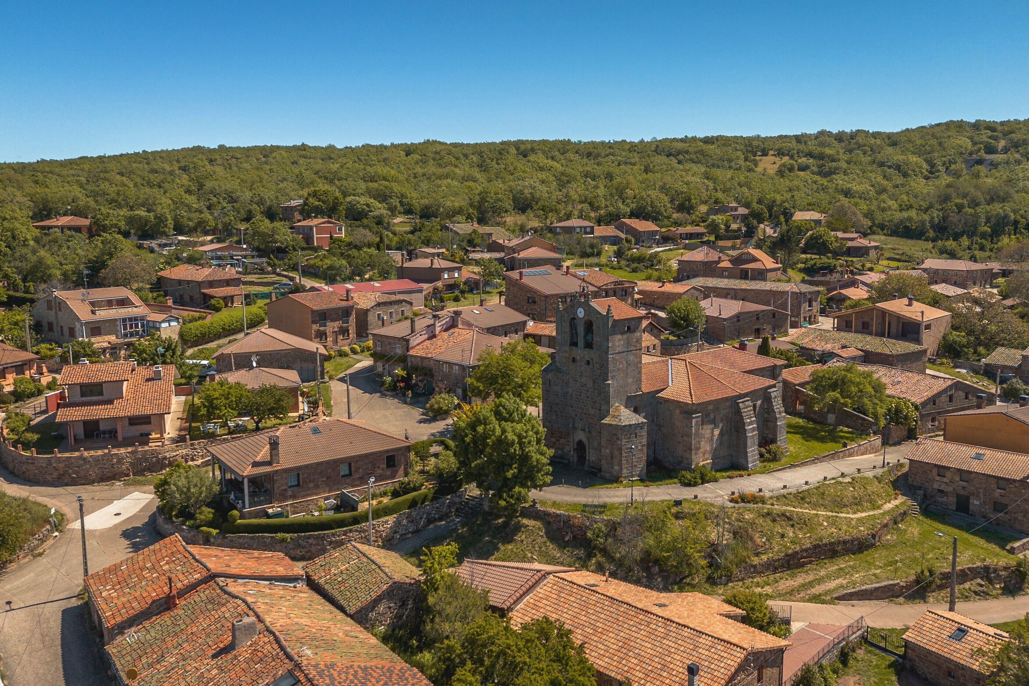 A village with traditional architecture, including stone buildings and a church.