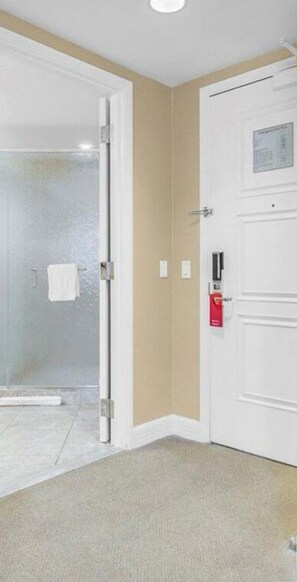Enjoy a comfortable stay in this well-appointed room featuring a glass shower enclosure and a convenient emergency phone.