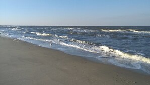 Una playa con olas rompiendo en la orilla.