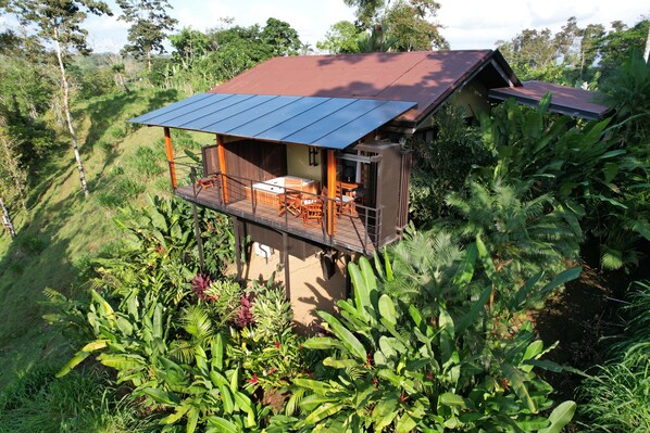 A house with a balcony, surrounded by lush greenery. - Romantic Private Villa w/ Hot Tub, Pool Access - Near La Fortuna and Arenal (La Fortuna)