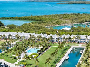 A resort with multiple buildings, a swimming pool, and a marina.