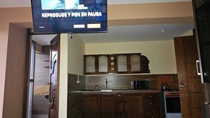 A modern kitchen with dark wooden cabinets, a stainless steel sink, and a microwave. - beautiful and warm apartment,  5 minutes from Cusco airport (Cusco)