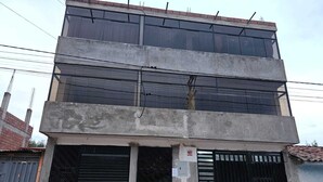 A multi-story building with large windows and a gated entrance. - beautiful and warm apartment,  5 minutes from Cusco airport (Cusco)